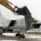A modified excavator cuts off the nose of Tu-22MS Backfire bomber on Priluki airfield, some 200 km from the Ukrainian capital Kiev, in this Friday, Feb. 2, 2001, file photo. Ukraine is set to scrap the country’s last heavy bomber Friday in the central Poltava region, the Defense Ministry said. The dismantlement complies with the START I nuclear treaty and the Conventional Forces in Europe treaty, and is financed under the Heavy Bomber Elimination Program, a U.S. congressional initiative that has provided more than US$650 million (euro530 million) to Ukraine to scrap the country’s strategic nuclear arsenal. (AP Photo/Efrem Lukatsky)